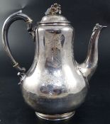 A Victorian silver baluster coffee pot, engraved with flower sprays, coats-of-arms and mantling with