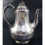 A Victorian silver baluster coffee pot, engraved with flower sprays, coats-of-arms and mantling with
