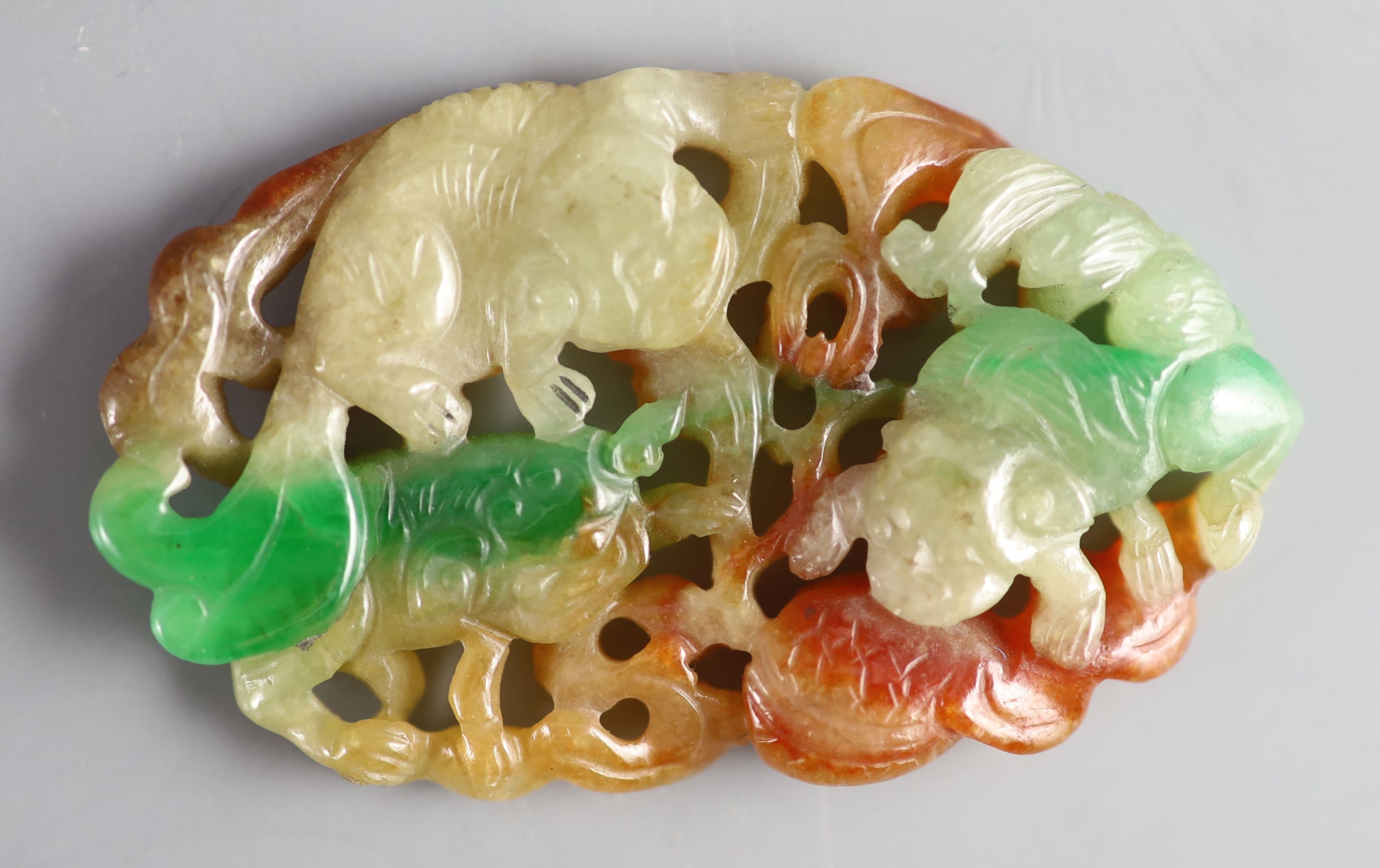 A Chinese three colour jadeite pendant plaque, 19th/20th century, skillfully carved to the emerald