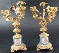 A pair of 19th century French ormolu and Sevres style porcelain three light candelabra, with lily,