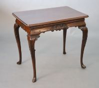 A George I style mahogany centre table, with rounded rectangular top and shaped apron carved with