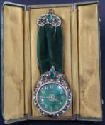 A 1930's Swiss bejewelled brass eight day pendant timepiece, encrusted with simulated emeralds and