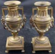 A pair of 19th century French ormolu urn shaped candlesticks, with lions mask ring handles, height