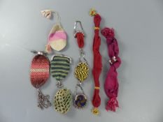 A group of assorted needlework and cut steel pursesCONDITION: - long puce fabric purse with two