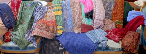 A large collection of fabric skirts including a raffier skirt in blue