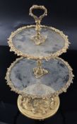 A Victorian ormolu and glass two tier cake stand, cast with vineous bands and rococo scrolls, height