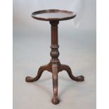 A George II mahogany wine table, with later dishes circular top, fluted and acanthus carved stem