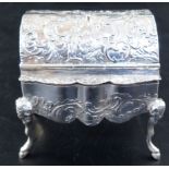 A Hanau embossed silver trinket box, formed as a miniature bureau, on mask and hoof feet, import