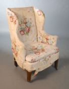 A George III mahogany wing armchair, with rounded squared legs and fitted brass castors, W.51cm D.