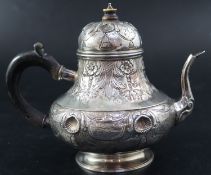 A late 18th/early 19th century Dutch embossed white metal pear shaped teapot, height 15.3cm, gross