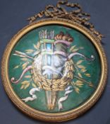 A 19th century French enamelled copper trophy plaque, in ormolu ribbon frame, decorated with a