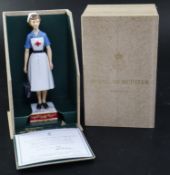 A Royal Worcester model of a British Red Cross Society V.A.D. Member, no.306/750, with original