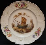 A Vinovo porcelain plate, painted with a beached fishing boat and figures, the basket weave border