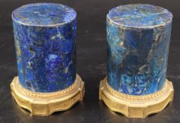 A pair of late 18th century ormolu mounted lapis lazuli socles, with laurel leaf and fluted