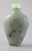 A Chinese blue-green jadeite snuff bottle, 1800-1900, of flattened shouldered form carved in low