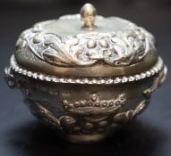 A 19th century Continental circular embossed white metal two handled pot and cover, 83mm, 99