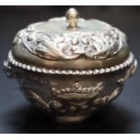 A 19th century Continental circular embossed white metal two handled pot and cover, 83mm, 99