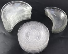 A set of twelve cut glass crescent shaped hors d'oeuvres dishes, with fan cutting to the base, 22cm,