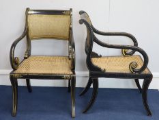 A set of seven Regency style parcel-gilt decorated ebonised armchairs, 19th century, the cane