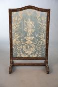 An Edwardian parcel gilt simulated bamboo fire screen, inset with an arched Lyonnaise silk panel