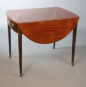 A George III mahogany Pembroke table, with oval top and frieze drawer on squared tapered legs,