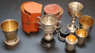 Two small silver trophy cups, largest 97mm, a modern silver gilt beaker and a group of assorted