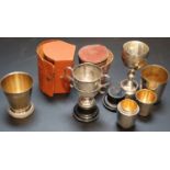 Two small silver trophy cups, largest 97mm, a modern silver gilt beaker and a group of assorted