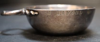 A 19th century French white metal wine taster, with plain bowl and two serpent handles, inscribed '