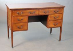 An Edwardian satinwood banded mahogany dressing table, fitted six drawers on squared tapered legs,