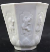 A Chinese Kangxi blanc de chine octagonal cup, moulded with figures and leaves, John Sparkes Ltd