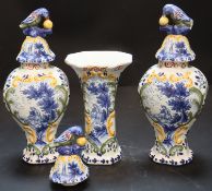 A 19th century Dutch delft polychrome part garniture of three vases, painted in blue with musicians,