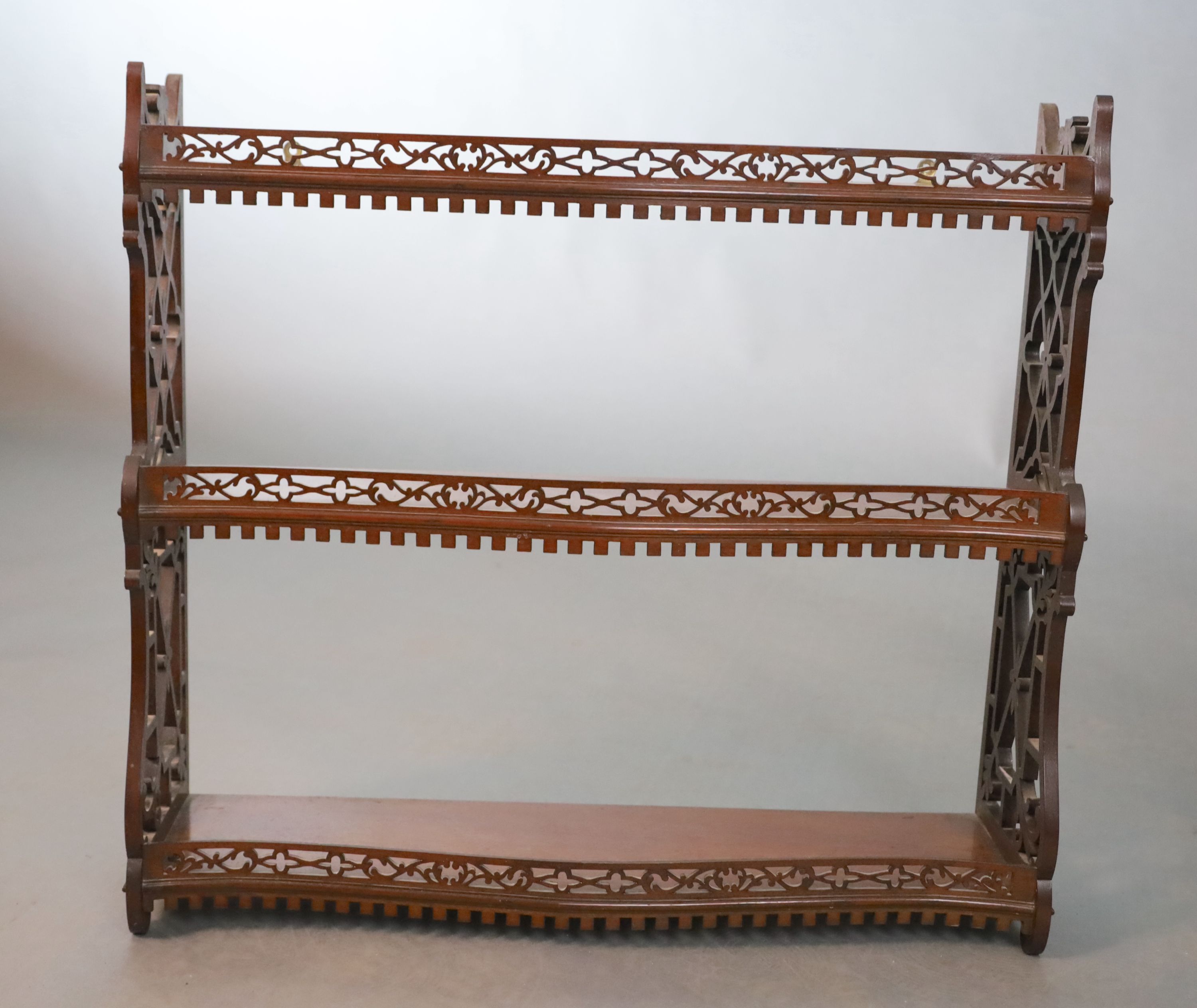 A George II style mahogany three tier wall shelf, with a dentil moulded apron within fretted side - Image 2 of 4