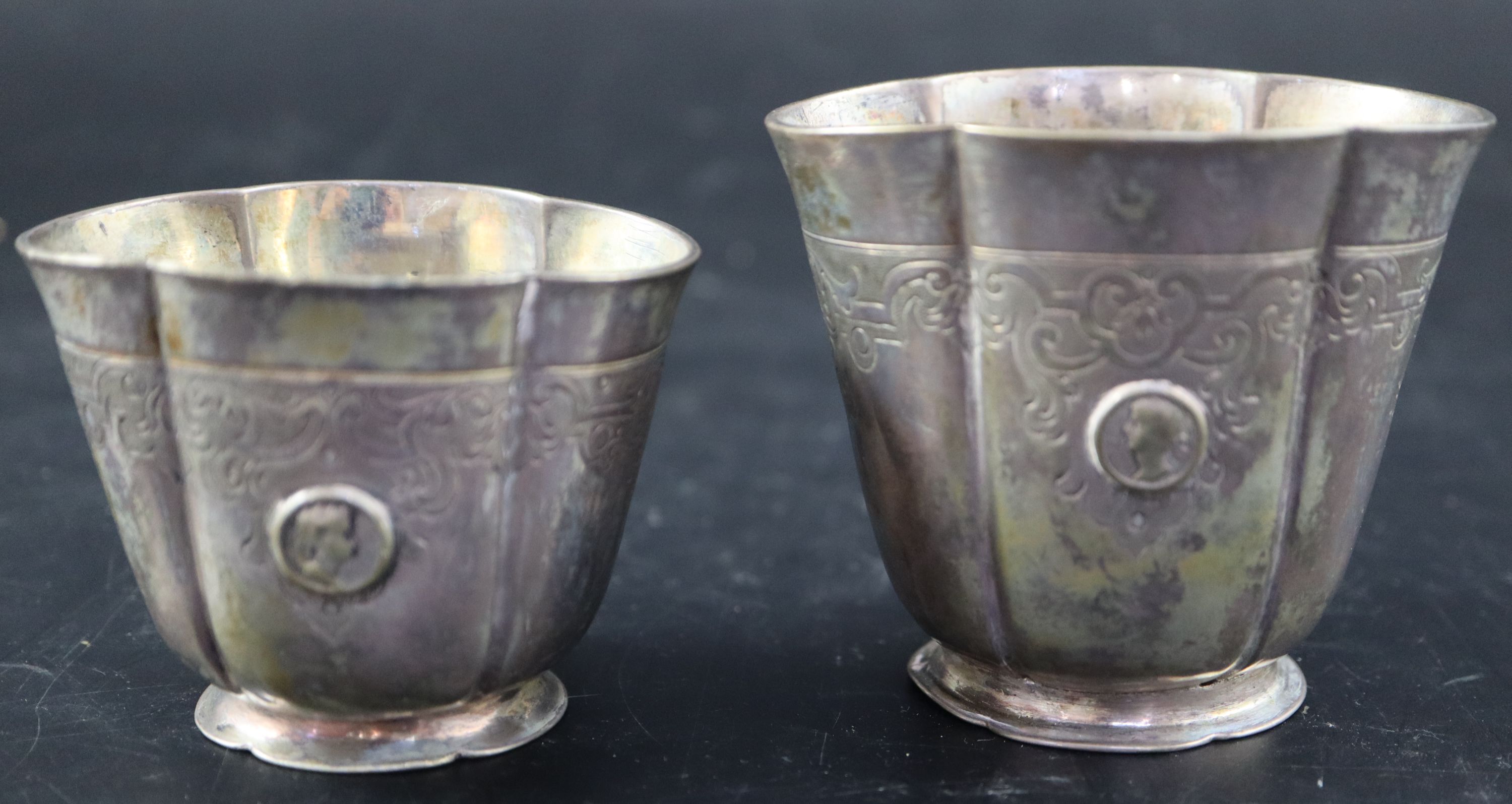 A graduated pair of Continental white metal cusped small vases, indistinct marks, tallest 7cm, 215