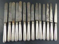 A set of twelve George IV silver handled thread pattern table knives, London, 1828 and two others (