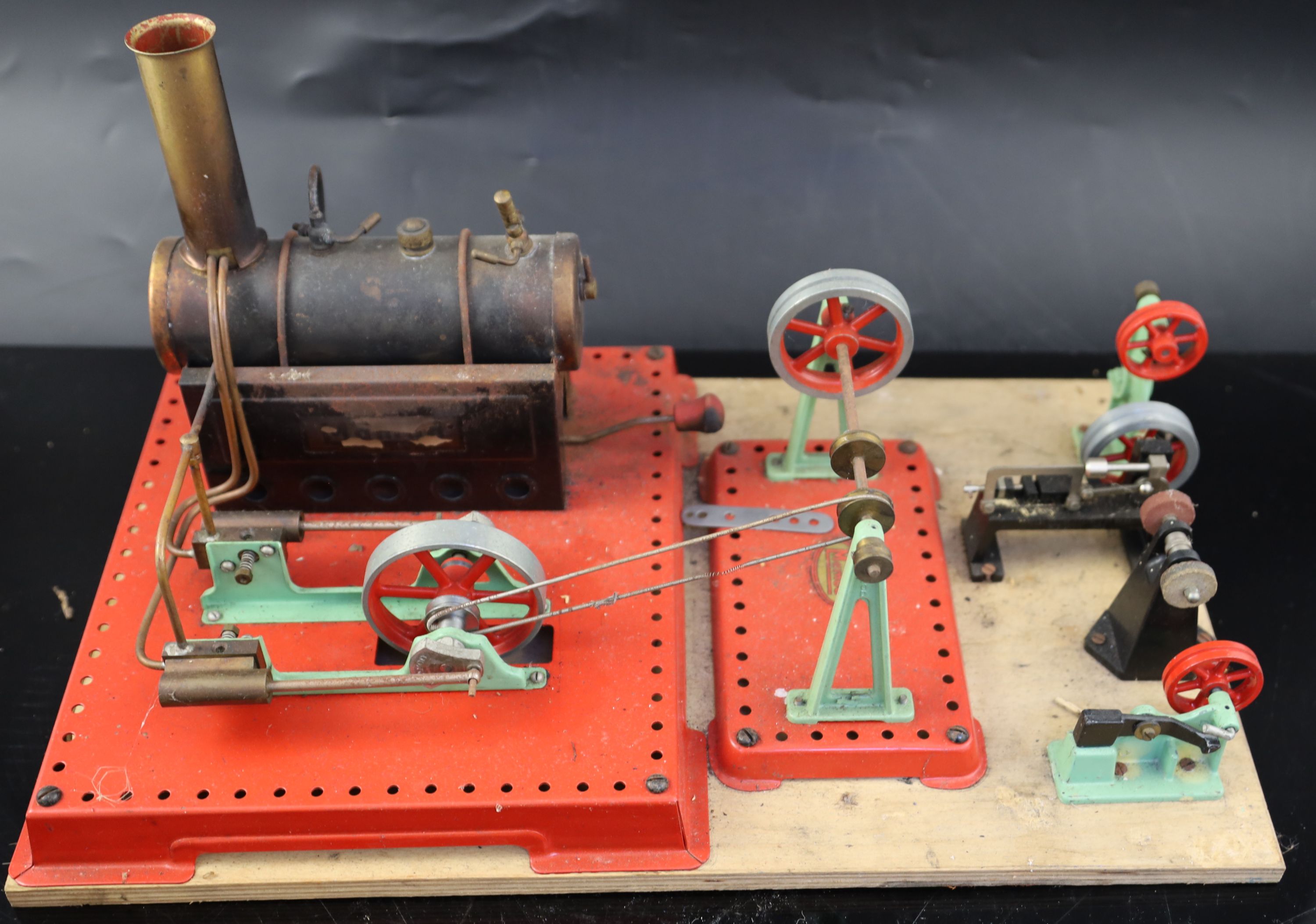 A Mamod tin plate steam engine driving a series of wheels, mounted on a board base, and - Image 5 of 7