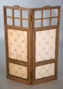 An Edwardian parcel gilt walnut dwarf two fold screen, the frame carved with flowers and foliate