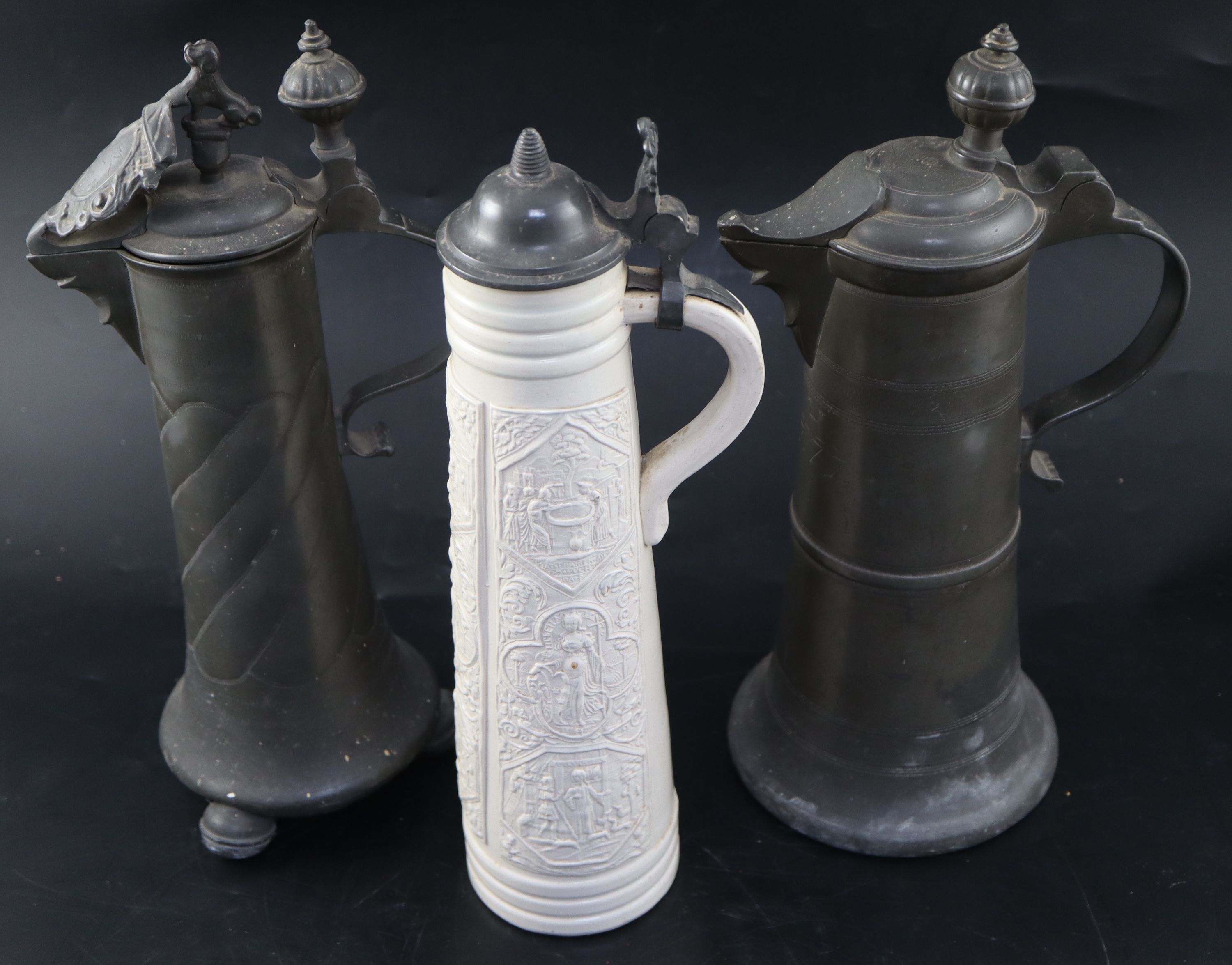 An 18th century Continental pewter flagon, initialled and dated 1777, height 35cm, a later flagon