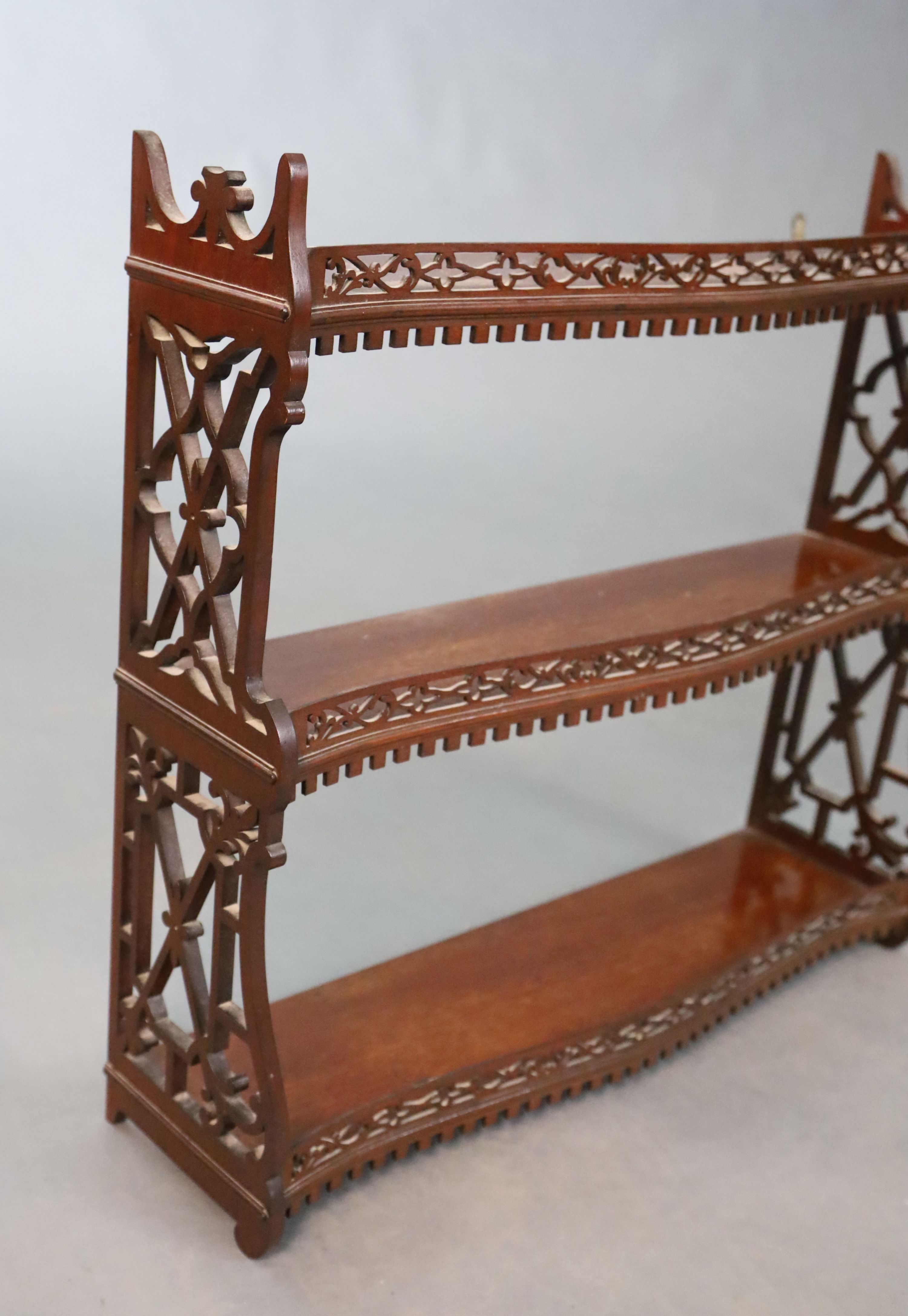 A George II style mahogany three tier wall shelf, with a dentil moulded apron within fretted side - Image 3 of 4