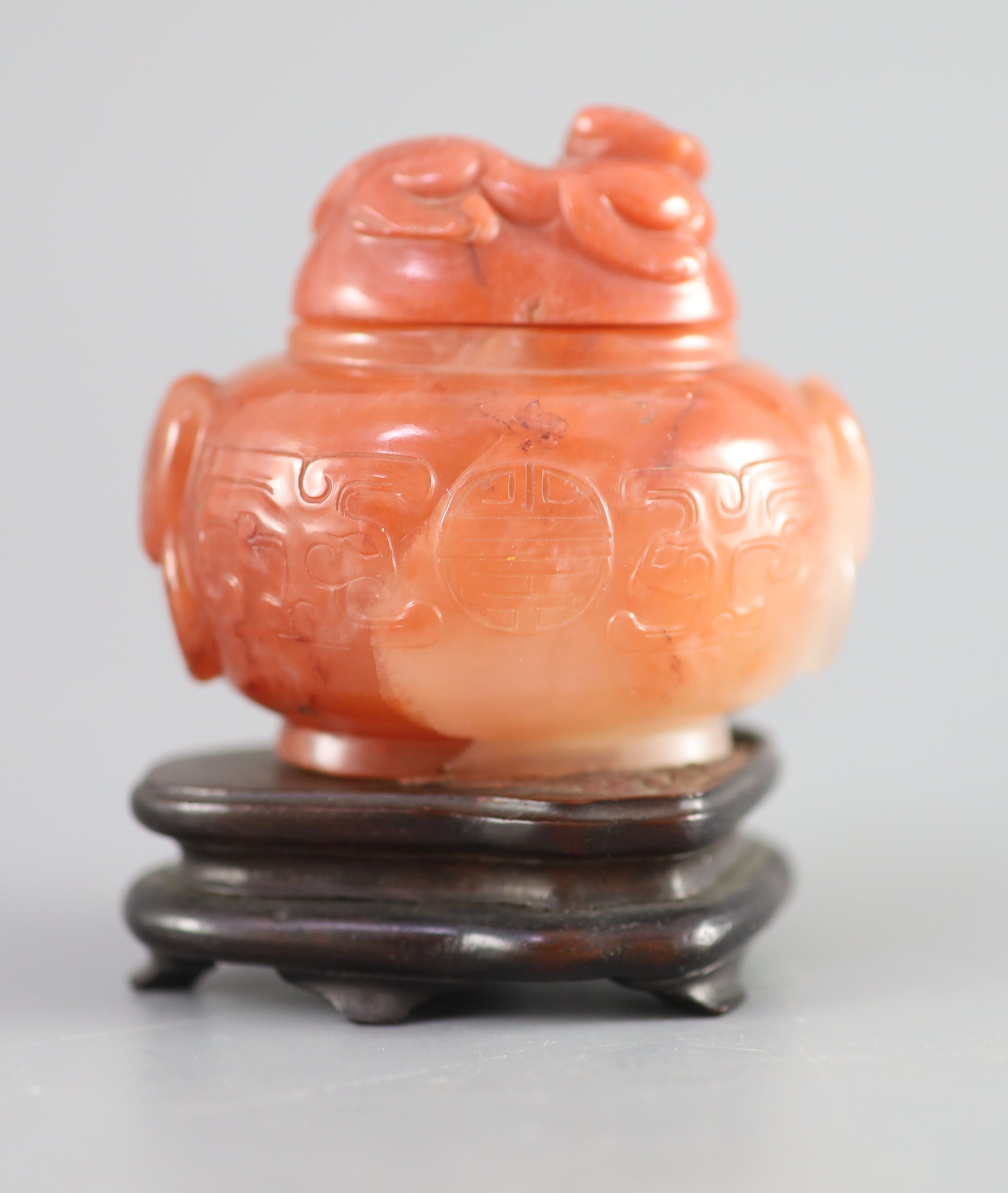 A small Chinese cornelian jar and cover, Qing dynasty, 18th/19th century, the globular vessel carved
