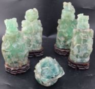 Four late 19th / early 20th century Chinese green quartz vases and covers, carved in relief with