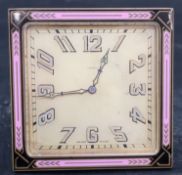 A mid 20th century Swiss enamelled brass eight day travelling timepiece, with pink and black