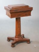 An early Victorian mahogany teapoy, with sarcophagus shaped rectangular top, fitted with three