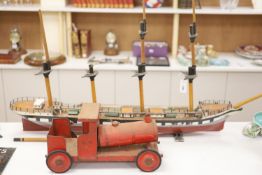 A scratch built primitive model of a cutter and an enamelled metal model of a locomotive, longest