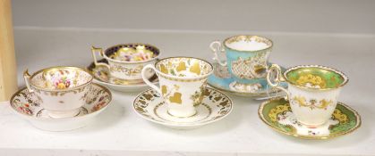 A Spode cup and saucer decorated with raised gilt birds and a basket with green leaves, marked Spode