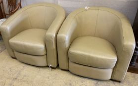 A pair of tub chairs upholstered in cream leather, width 86cm, depth 75cm, height 74cm