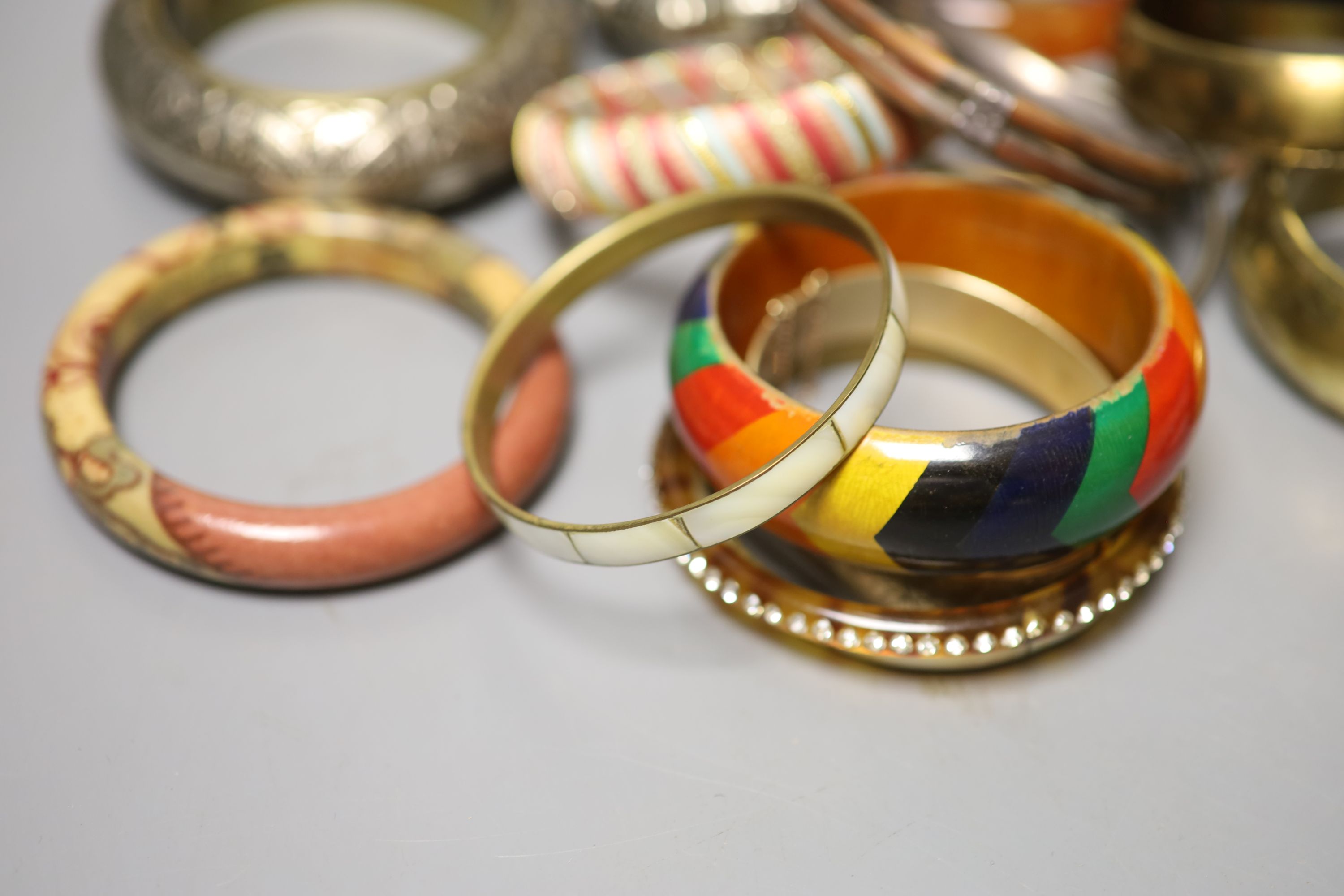 A collection of bangles, including five ethnic white metal examples, a faux tortoiseshell bangle - Image 2 of 5