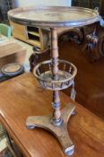 An early Victorian circular rosewood candlestand with galleried shelf on platform base, diameter