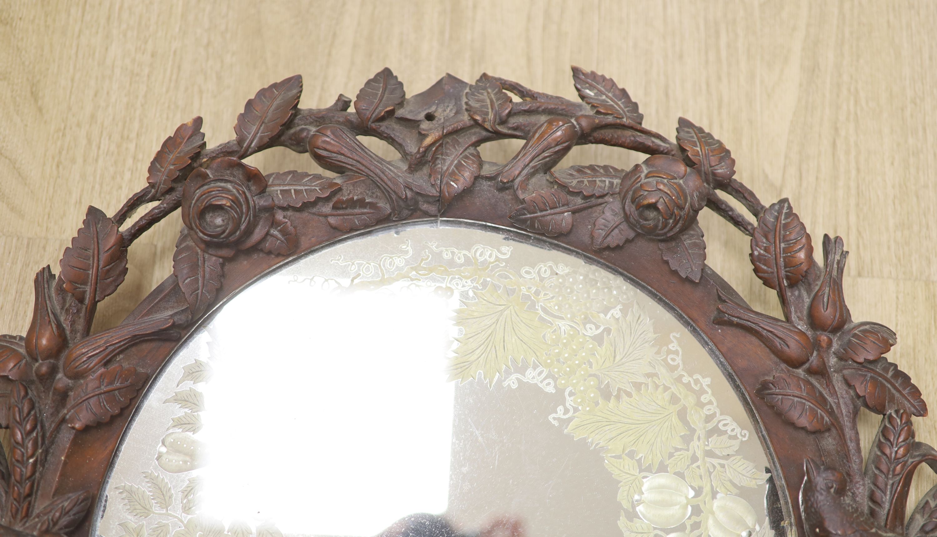 A 19th century Black Forest walnut wall mirror carved with roses and birds, diameter 56cm - Image 3 of 3