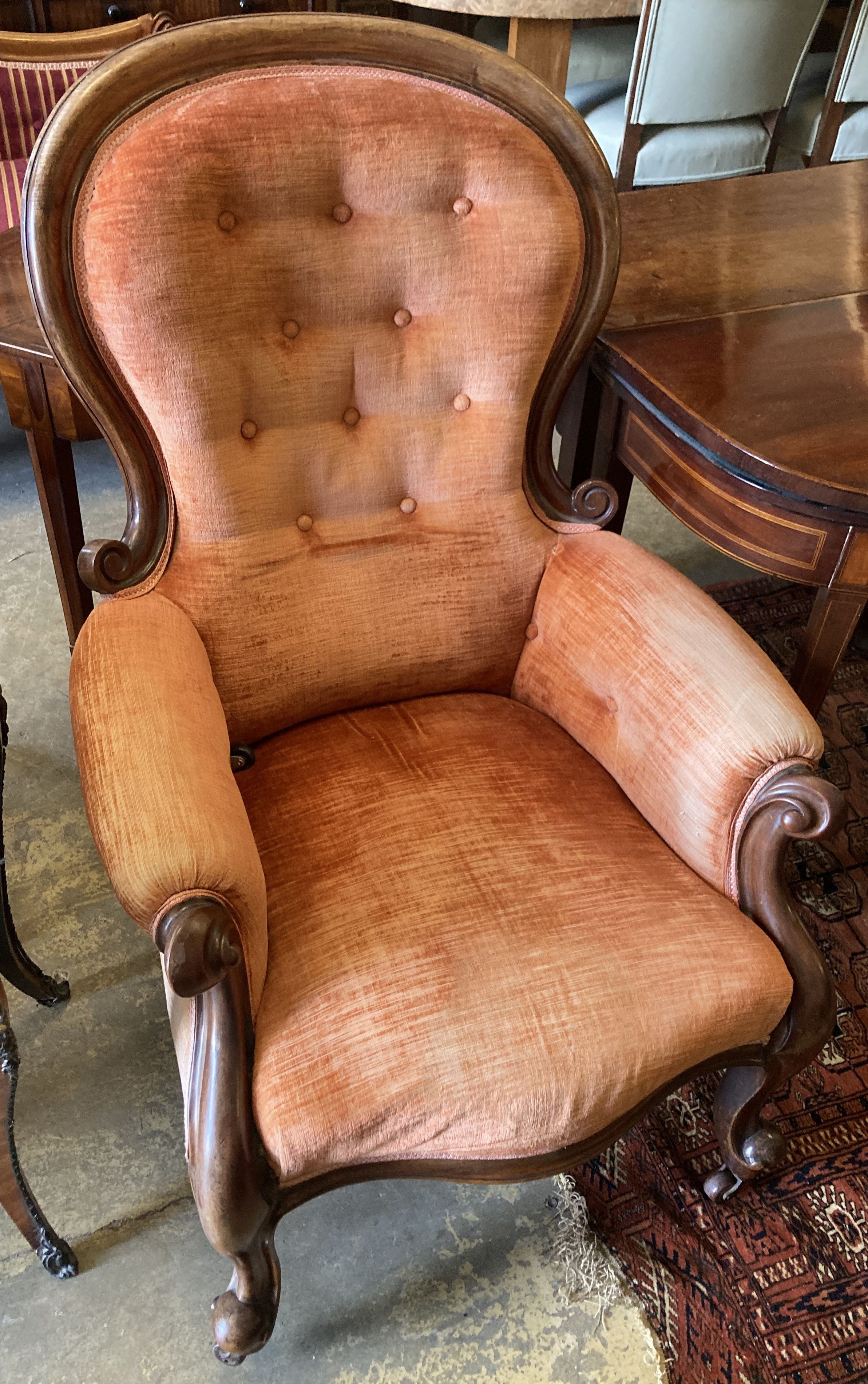 A Victorian carved mahogany spoonback armchair, width 72cm, depth 70cm, height 105cm
