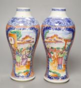 A pair of Chinese Qianlong period mandarin vases, decorated with figures and landscapes in